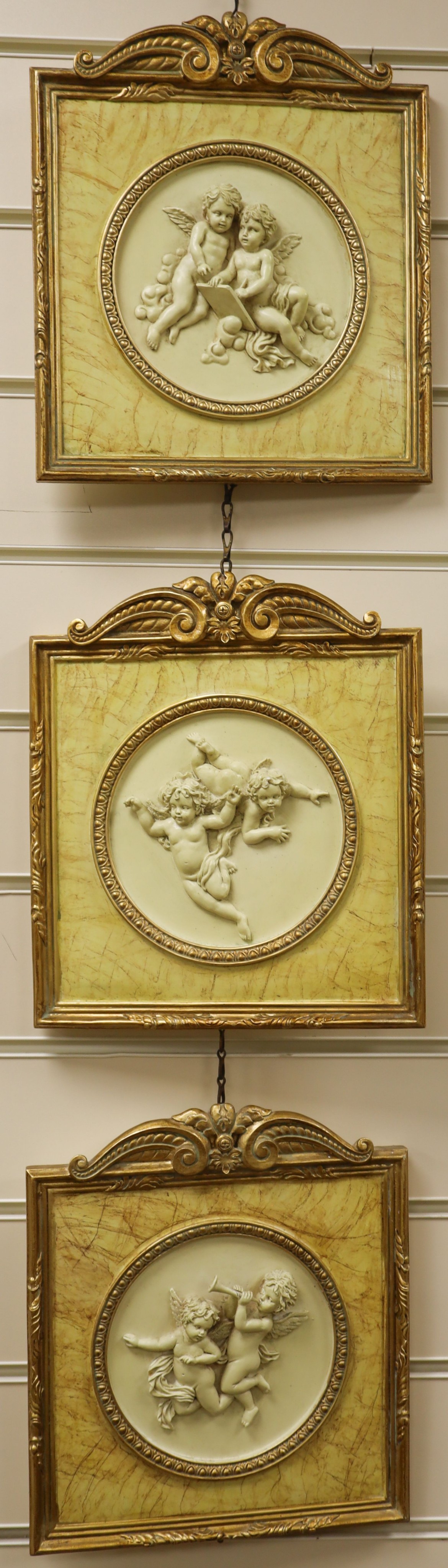 A set of three gilt framed composition plaques 27x23cm